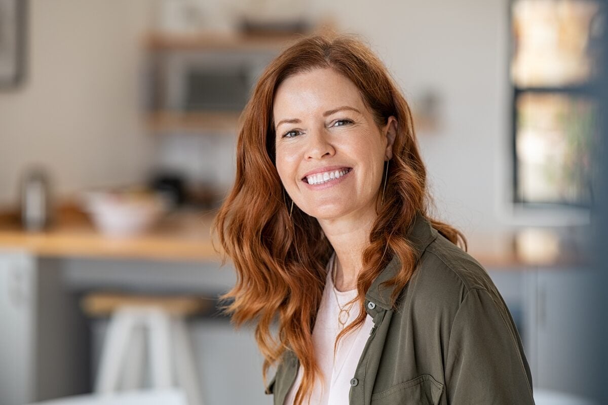A woman smiling in her kitchen