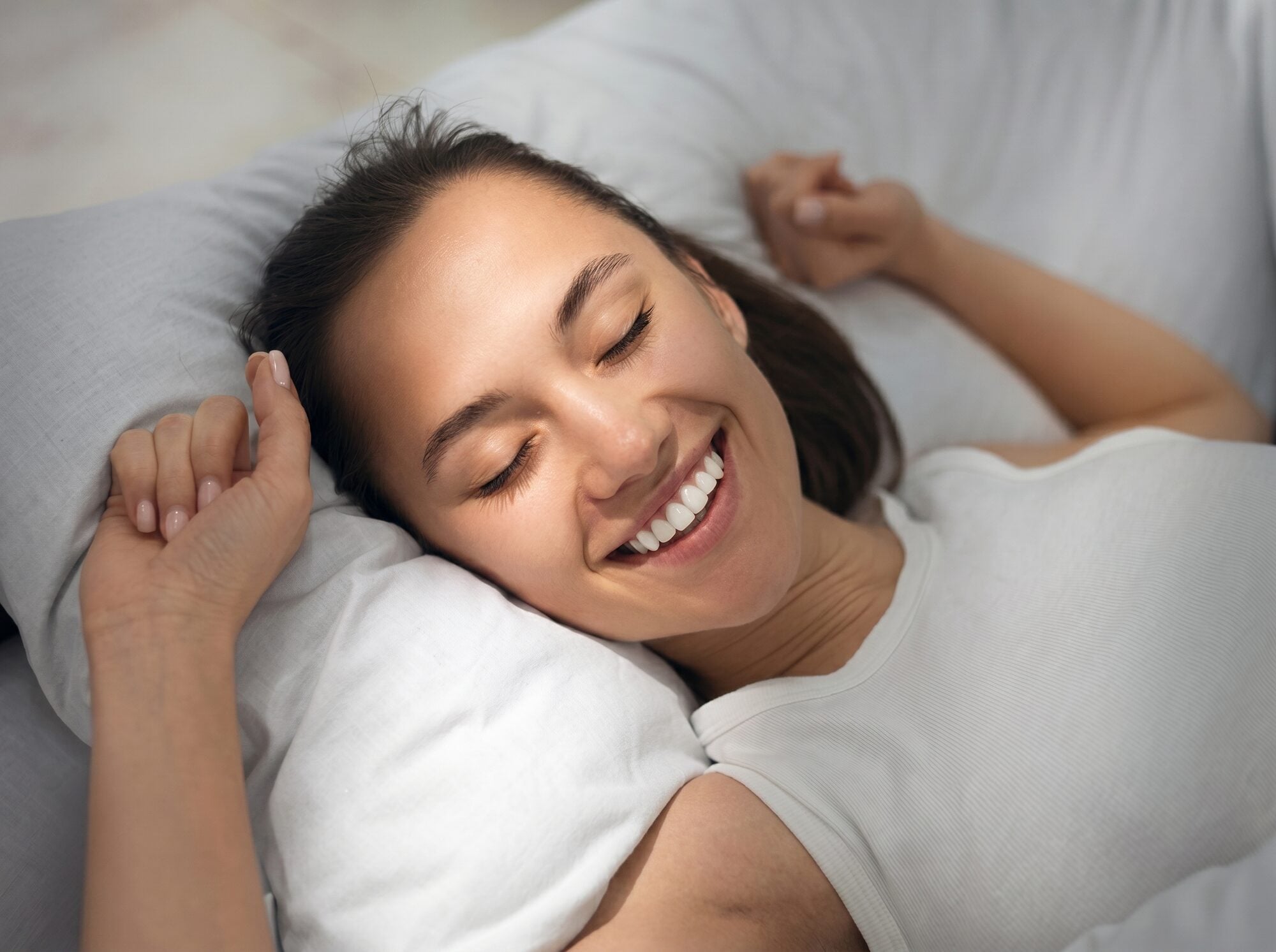 A woman waking up relaxed and smiling
